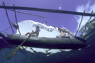 local kids in a canoe - MV Chertan - PNG Liveaboards